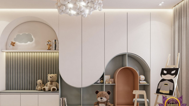 This picture shows a modern bedroom with a bed surrounded by light blue walls, white flooring, and a window on one side. The bed has a tufted headboard, white bedding, and several pillows scattered on it. On the opposite wall is a large abstract painting in shades of blue, white and grey, adding color and texture to the space. The room is accented with a round mirror and contemporary lighting fixtures.