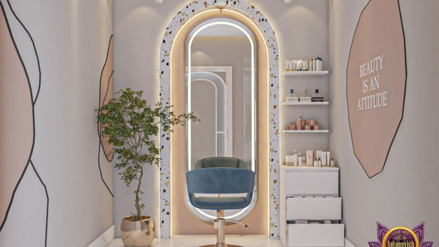 This picture shows an example of a modern minimalist interior design. It features light-colored walls and polished concrete flooring with a grey sofa, ottoman and white armchair as the main furniture pieces. The walls are decorated with two abstract paintings, and a minimalist white bookshelf. The room is finished off with a sleek white coffee table, along with a few potted plants for decoration.