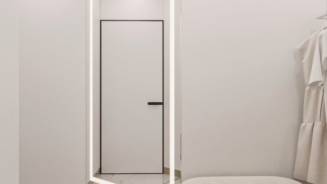 This picture shows a traditional Mediterranean-style interior design. The room is spacious and bright, with white walls and light hardwood flooring. Above the sofa is an ornate wall mirror, surrounded by a cream-colored frame with gold accents. There are multiple couches and armchairs in the room, with a central glass coffee table. Along one wall is an intricately-designed china cabinet with various decorative vases, plates and jars. An elegant chandelier hangs from the ceiling and provides light to the entire room.