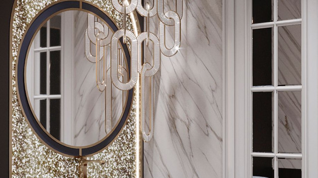 This picture appears to be a luxury bathroom interior design. It features a large oval-shaped spa bath tub, with a chrome faucet and drain. A white marble wall is behind it, along with two side tables topped with lamps and plants. Two white armchairs sit opposite the tub, and the overall color palette used is white, grey and chrome.