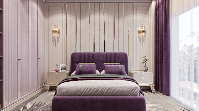 This picture shows the interior of a luxurious home. The floor is made up of white marble, and two wooden armchairs are placed in front of a large window with sheer white drapes. The walls are a light beige color with gold accents, and there is an ornate mirror above the fireplace. Besides the armchairs, there is a large cream sofa with decorative pillows and a glass coffee table. On the coffee table is an artful vase filled with bright flowers. The room is lit by a chandelier, giving it an elegant and sophisticated feel.