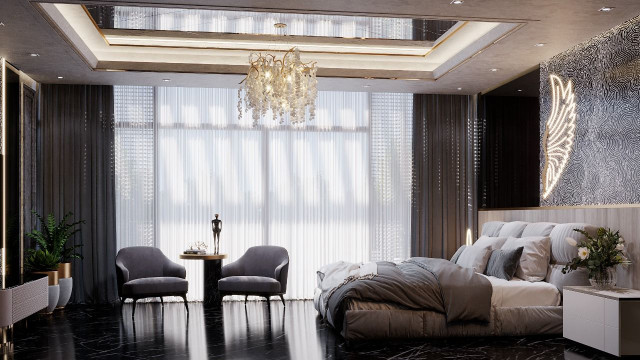 A grand, modern living room with artfully laid stone flooring, luxurious ivory furniture, and pale grey walls with accents of bright gold.