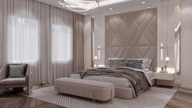 A luxurious marbled lobby with a grand staircase, featuring ornate gold-leafed ceilings and chandelier, luxuriously upholstered furnishings, and a grand piano.