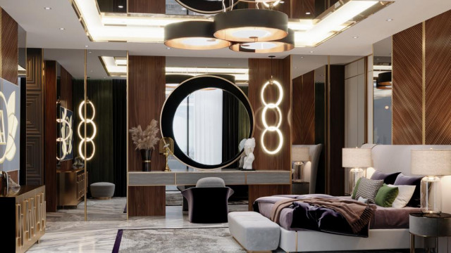 This picture shows an ultra-luxurious modern bedroom designed by Antonovich Design. The room is decorated in a stylish black and white color scheme, with some accents of gold. The room features a high, curved ceiling with large windows providing views of the outside. The bed sits in the center of the room and is framed by custom-designed lighting that creates a romantic atmosphere. To the side, there is a luxurious chaise lounge and a shelf filled with books and decorative items. Finally, the room is finished with a beautiful carpet providing extra comfort underfoot.