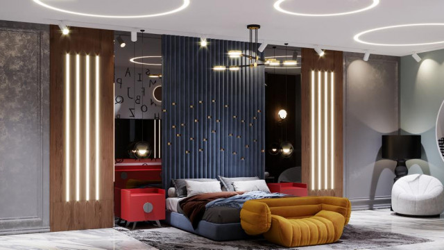 Brightly decorated bedroom with a large king-size bed, two end tables and a chaise lounge chair in the corner, adorned with colorful throw pillows.