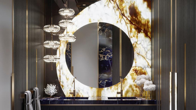 This picture appears to show a modern, sophisticated living room with a large abstract painting on the wall. The furniture in the room is minimalist and contemporary, with a sleek black leather sofa and armchairs, a white side table, and an area rug with a geometric pattern. The lighting fixtures in the room are also modern, with a sculptural hanging chandelier in the center of the room. The overall look creates a stylish and inviting space.