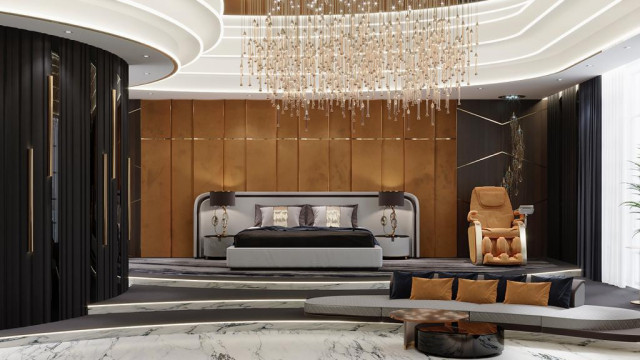 Modern living room with white furniture, featuring a comfortable sectional sofa, a round glass coffee table, and an accent wall decorated with family pictures.