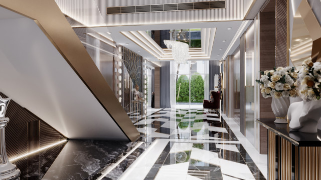 This picture shows a modern luxurious living space. It features an oversized light grey sofa with blue and white accents, framed artwork, and a large glass coffee table. The walls are painted a light shade of grey, and a large crystal chandelier hangs from the ceiling. There is also a white rug, patterned curtains and potted plants throughout the room, creating a warm and inviting atmosphere.