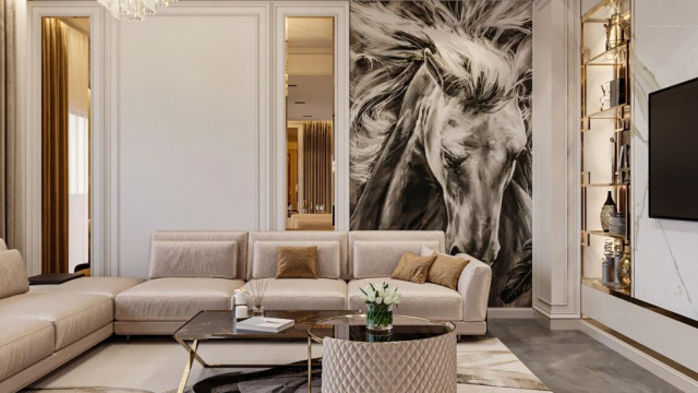 A luxurious home interior decorated with an ornate chandelier, marble flooring, accent wall, and upholstered furniture.