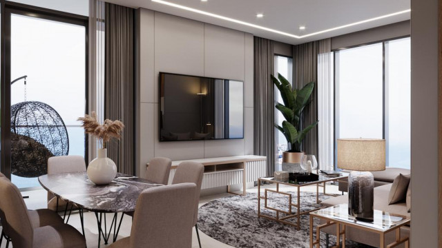 This picture is of a luxurious modern living room. The room features a dark hardwood floor, a grey sectional couch, and a white marble fireplace with a built-in shelving unit. There is also a large abstract painting hanging on the wall and a glass coffee table in front of the couch. The room is well-lit by a chandelier and a few other recessed light fixtures.