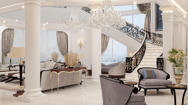 Modern luxury living room with ornate furniture upholstered in beige fabric and an intricately patterned area rug.