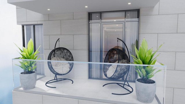 This picture shows an elegant and luxurious dining room with a large, round wooden table at the centre. The walls are painted in a rich shade of burgundy, with a white ceiling and golden accents. A large crystal chandelier hangs above the table and the room is decorated with several pieces of art, including a mounted animal head on one wall. The floor is finished in a light hardwood, with a deep red rug beneath the table.