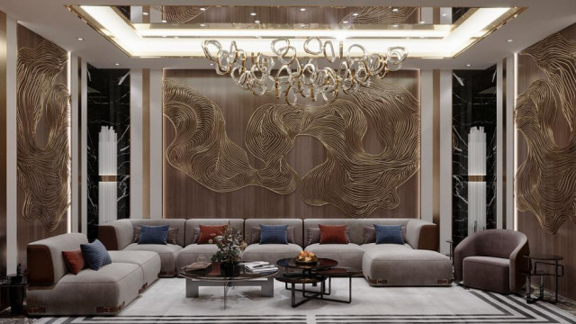 This picture is a photo of a luxury living room interior design. The room features a contemporary style with modern furnishings including a white leather sectional sofa, a large glass coffee table, and stylish side tables. The walls are painted a light gray color and the floors contain dark hardwood. There is also a fireplace on one wall and an inviting rug in the center of the room.