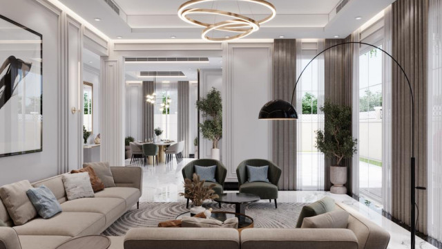 Modern interior design featuring large U-shaped sofa in ivory upholstery, offset by accent chairs in bright floral pattern. Dark wood coffee table with glass top, complete with decorative accents and stylish lighting fixtures.