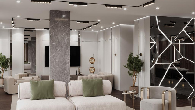 Modern living room with neutral color scheme featuring textured sofa, accent chair, glass-top coffee table and large abstract artwork.