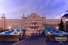 This picture appears to be a close-up of a bright orange butterfly on a yellow flower. The butterfly has black stripes and spots on its wings, and its body appears to have a yellow stripe down the back. The flower has yellow petals and a white center.