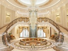 This photo shows a small, white smartphone with a brick wall behind it. The phone appears to be in the center of the frame and is lit up, illuminating the surrounding brickwork. There are several different shades of orange and red in the bricks, creating a warm atmosphere. The phone's screen is blank, giving the photo an unfinished feel.