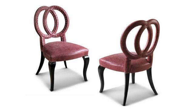 Luxury Chair in leather upholstery with chromed nails and black polish lacquered legs